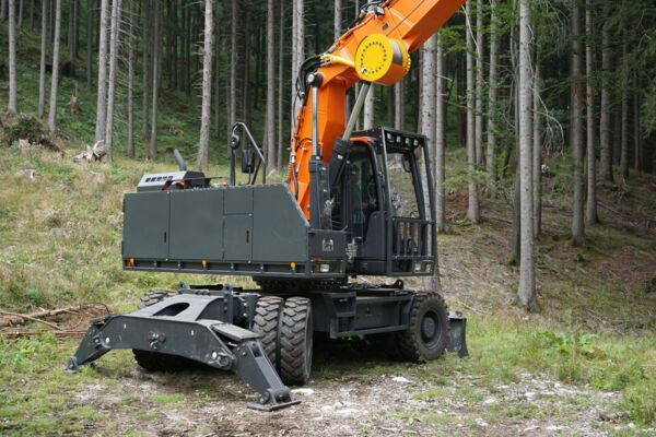 Timber grabber machine with an orange arm working in the forest